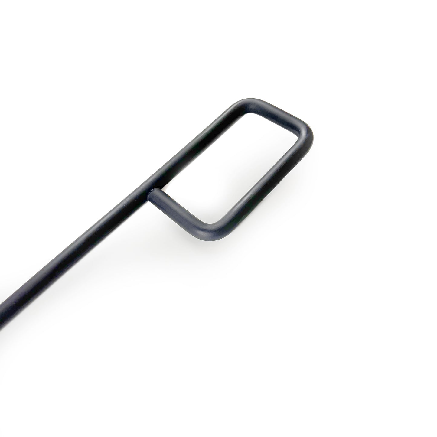 Close up on the detail of a modern, rounded steel fire pit poker handle.