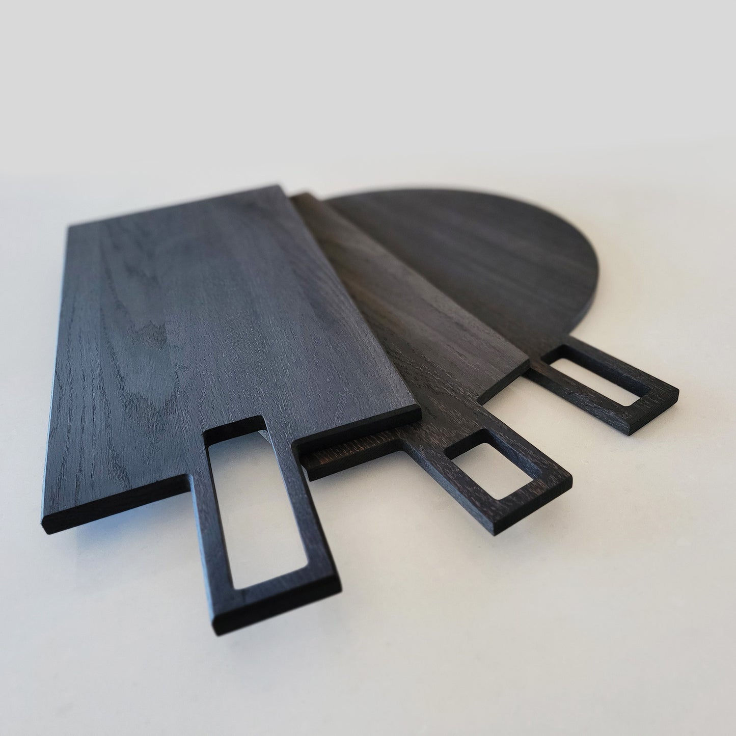 Oversized, blackened oak, food grade charcuterie boards. Ideal for serving many people at once. Big Wide Outside. Available in three designs - Full Circle, Oblong and Taper.