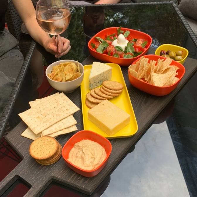 Oversized blackened oak serving board from Big Wide outside. Ideal for eating outdoors for charcuterie, cheese and appetizers. Served on Ekobo Gusto Dish ware.