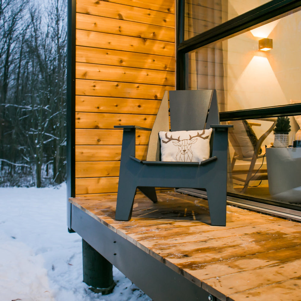 
                  
                    Shot of Ori Muskoka with cushion sitting on porch of Scandinavian cabin, in winter.
                  
                