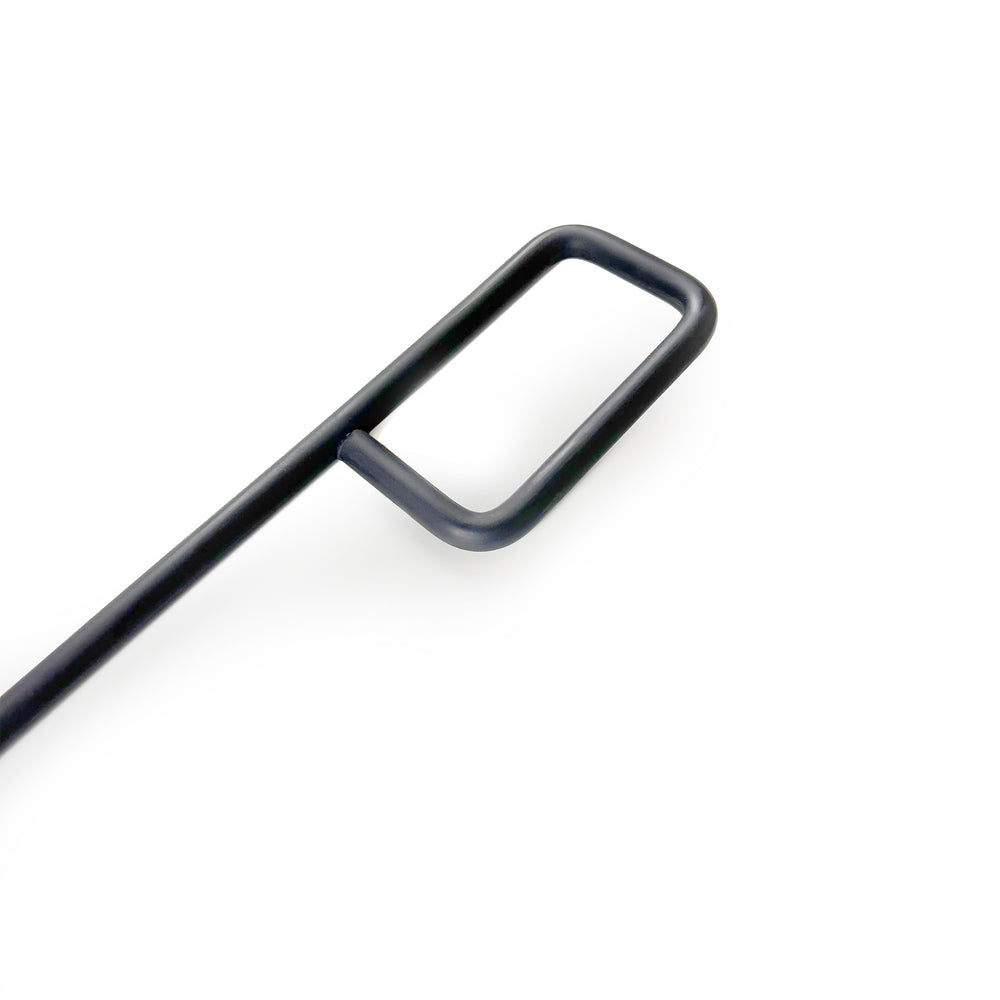 
                  
                    Close up on the detail of a modern, rounded steel fire pit poker handle.
                  
                