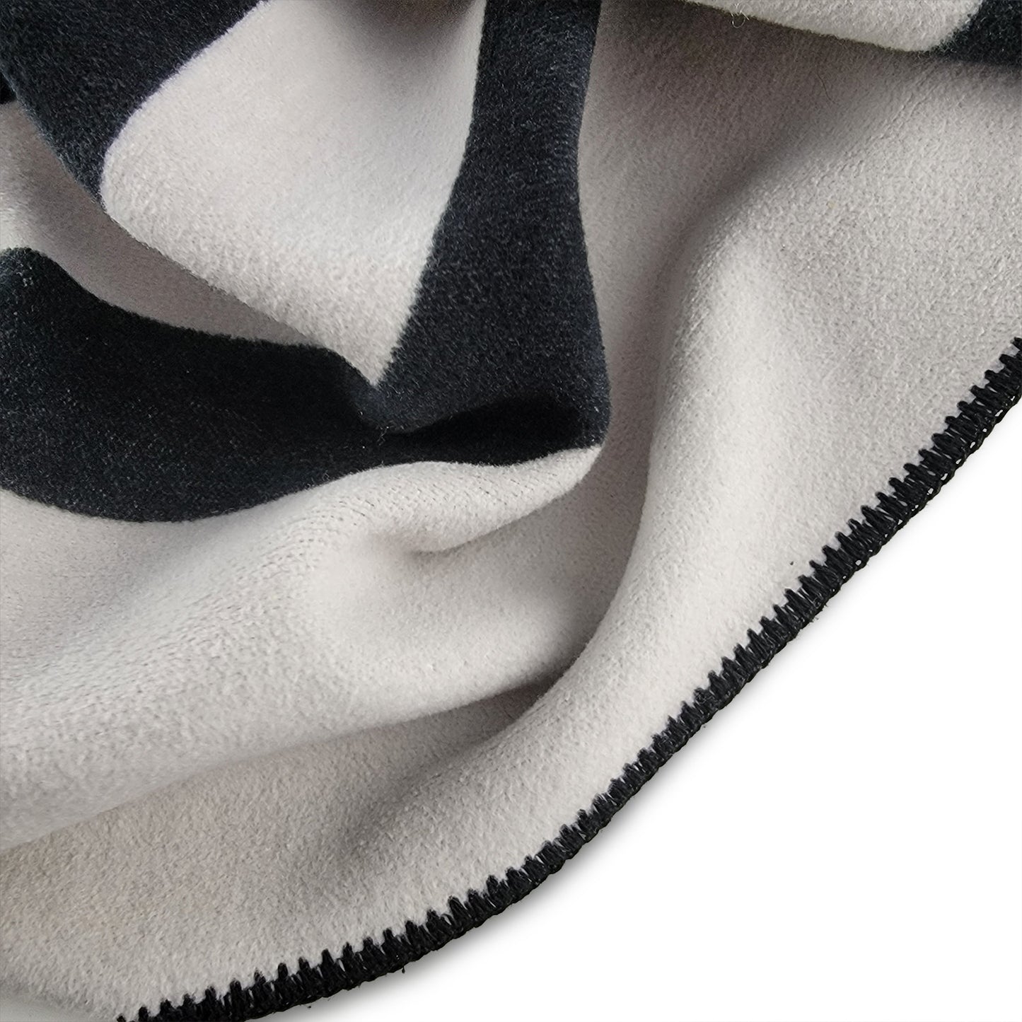 
                  
                    Close up detail of beautiful Snowden Cotton Blanket with black and white stripes and beautiful stitching.
                  
                