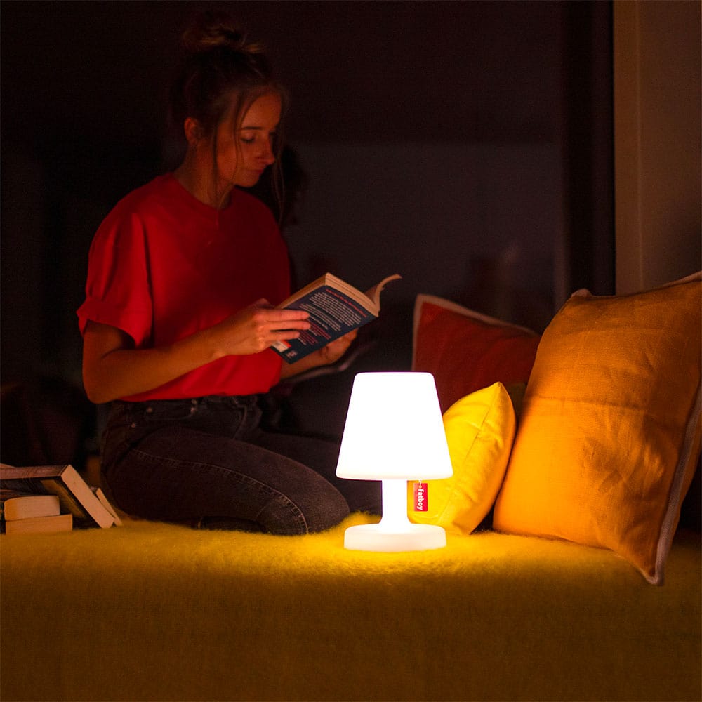 
                  
                    Lady reading a book lit by a portable LED light. E
                  
                